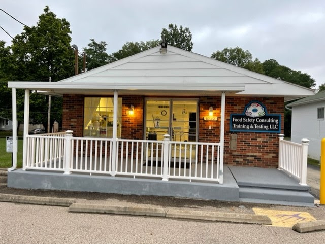 Freestanding brick office building with white covered porch on North Dixie Drive
